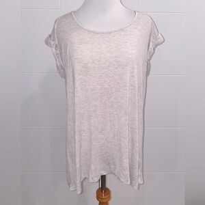 Cream t shirt, stretchy, with peep hole on upper back.